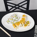 A Homer Laughlin bright white china platter holding sushi on a table.