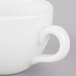 A close-up of a Homer Laughlin bright white espresso cup with a handle.