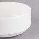 A Homer Laughlin Ameriwhite Alexa china bowl with a white rim on a gray surface.