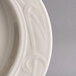 A close-up of a Homer Laughlin ivory china platter with a design on the edge.
