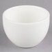 A Homer Laughlin bright white china bouillon bowl on a gray surface.
