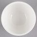 A Homer Laughlin Alexa white china bouillon bowl on a gray background.