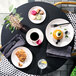 A table in a brunch café set with Homer Laughlin Alexa china cups filled with coffee and lemonade.