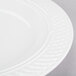A close-up of a Homer Laughlin bright white china pasta bowl with a pattern on it.