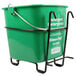A green San Jamar sanitizing pail with a black wire wall mount holder.