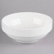 A Homer Laughlin bright white bowl with a white rim on a gray surface.