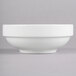A Homer Laughlin bright white bowl with a white rim on a gray surface.