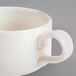 A Homer Laughlin ivory china soup mug with a handle.