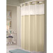 A beige Hookless shower curtain with white trim and a translucent window.