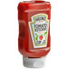 A close up of a Heinz tomato ketchup bottle with white cap and label.