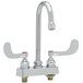 A silver T&S deck mount faucet with two wrist action handles.