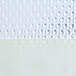 A close-up of a white fabric shower curtain with bubble-textured window and holes for Flex-On rings.