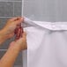 A person snapping white It's A Snap! shower curtain liner magnets together.