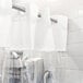 A white Hookless shower curtain with a clear vinyl window hanging in a bathroom.