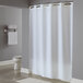 A white Hookless shower curtain with flat flex-on rings in a bathroom.