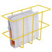 A yellow Noble Products wire rack holding papers and folders.