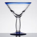 A close-up of a Libbey martini glass with a blue rim and clear base.