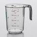 A clear plastic WebstaurantStore measuring cup with a handle and measuring scale.
