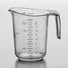 A WebstaurantStore clear plastic measuring cup with a handle and a measuring scale.