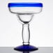 A Libbey margarita glass with a blue rim and base.