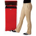 A woman standing next to a red Rubbermaid medical waste step can.