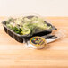 A salad in a Polar Pak clear plastic hinged take-out container.