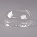 A clear plastic dome lid with a hole on a white background.