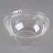 A clear plastic dome lid with a hole on a clear plastic bowl.