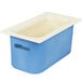 A white Carlisle Coldmaster food pan in a blue and white container.