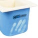 A white Carlisle divided plastic food pan with blue CoolCheck handles.