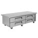 A Turbo Air stainless steel chef base with four grey drawers.