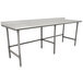 A stainless steel Advance Tabco work table with a white surface and legs.