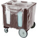 A dark brown plastic dish caddy with vinyl cover on a cart.