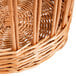 A Matfer Bourgeat round wicker bread basket with a handle.