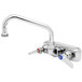 A chrome T&S wall mount faucet with two handles and a 12" swing nozzle.