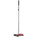 A red and black Oreck Hoky floor sweeper with a black pole.