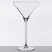 A Spiegelau Willsberger martini glass with a thin stem on a table.