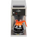 A Bloomfield commercial pourover coffee maker with a black and orange coffee pot.