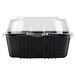 A black plastic Polar Pak hinged take-out container with a clear lid.