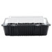 A black Polar Pak clear hinged take-out container with a clear lid.