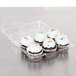A Polar Pak clear plastic container holding cupcakes with white frosting and sprinkles.