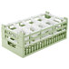 A light green plastic Vollrath glass rack with 10 compartments.