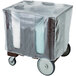 A dark brown plastic covered box on a cart with wheels.
