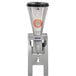 An Omcan high performance vertical tilting blender with a silver metal stand and black lid.