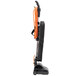 A black and orange Hoover Task Vac commercial bagged vacuum cleaner with a handle and a bag with a zipper.