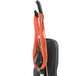 A Hoover Task Vac commercial bagged vacuum cleaner with orange cables and tubes.