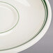 A close-up of a white Homer Laughlin saucer with a green rim.