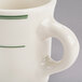 A white mug with green stripes on the rim.