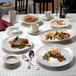 A table with Homer Laughlin ivory oval china platters set up for a meal.