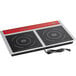 An Avantco red and black double countertop induction range on a counter with a cord.